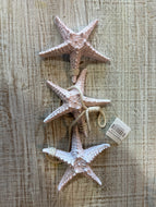 3 hanging pink starfishes