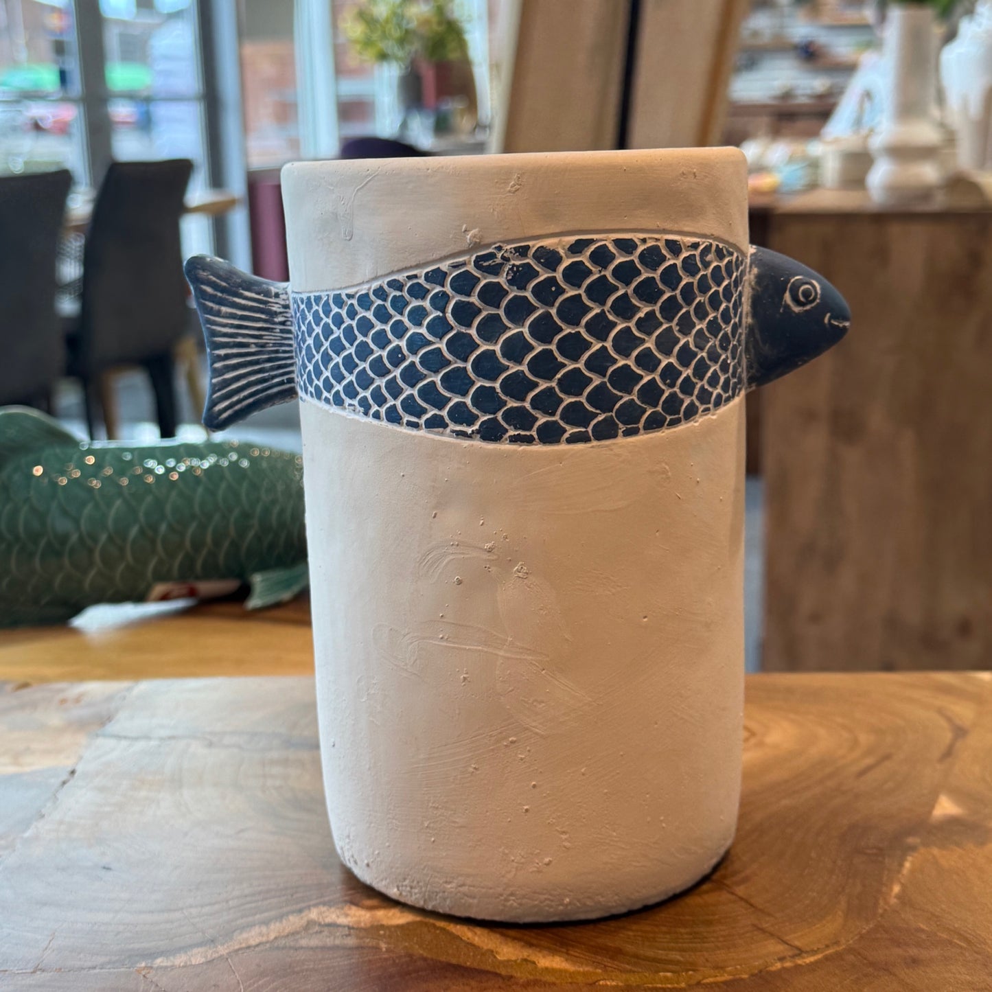 Tall pottery container with blue fish