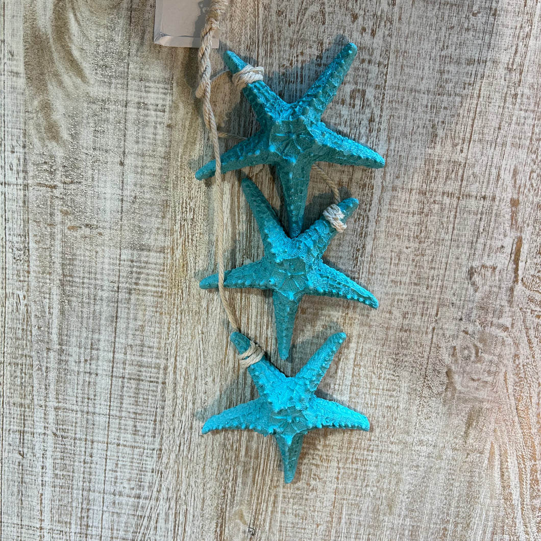 3 hanging turquoise starfishes